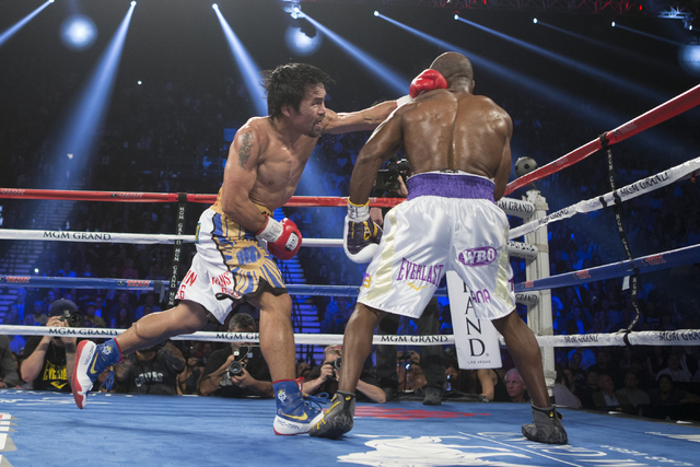 Manny Pacquiao, left, connects a left punch against Timothy Bradley in the WBO International welterweight championship boxing bout at the MGM Grand Garden ArenaSaturday, April 9, 2016, in Las Vega ...
