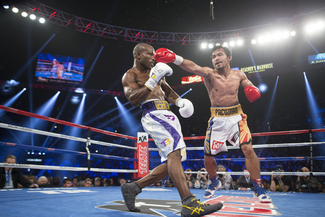 Timothy Bradley, left, moves away from a punch by Manny Pacquiao in the WBO International welterweight championship boxing bout at the MGM Grand Garden ArenaSaturday, April 9, 2016, in Las Vegas.  ...