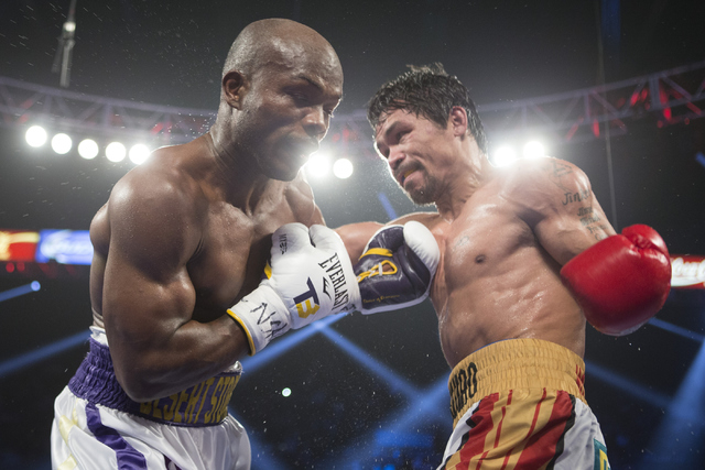 Manny Pacquiao, right, throws a punch against Timothy Bradley in the WBO International welterweight championship boxing bout at the MGM Grand Garden ArenaSaturday, April 9, 2016, in Las Vegas. Pac ...