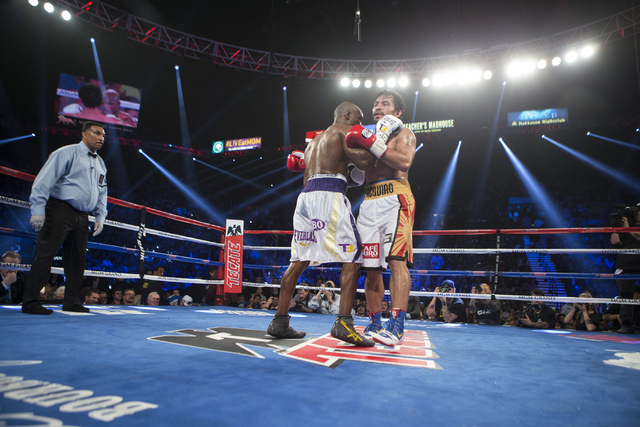 Timothy Bradley, left, and Manny Pacquiaoembrace at the start of the 12th round of the WBO International welterweight championship boxing bout at the MGM Grand Garden ArenaSaturday, April 9, 2016, ...