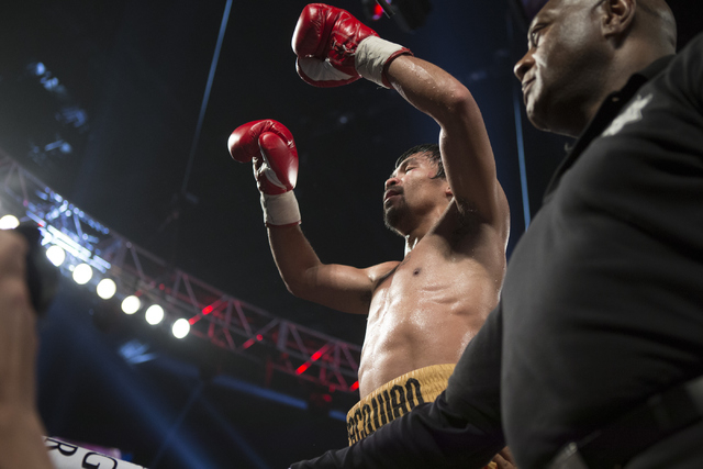 Manny Pacquiao celebrates his victory against Timothy Bradley in the WBO International welterweight championship boxing bout at the MGM Grand Garden Arena on Saturday, April 9, 2016, in Las Vegas. ...