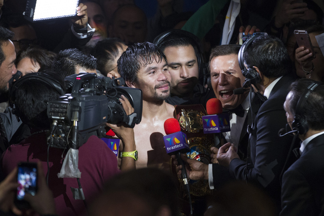 Manny Pacquiao is interviewed by boxing legend Julio Cesar Chavez after his victory against Timothy Bradley in the WBO International welterweight championship boxing bout at the MGM Grand Garden A ...