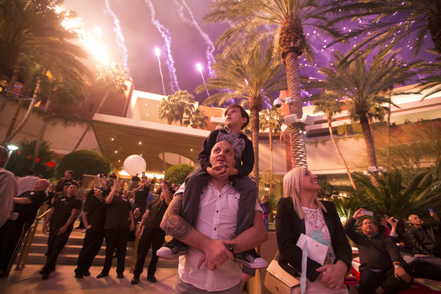 Giuseppe Acquisto, with his 9-year-old son Flavio on his shoulders, and his wife Patrizia, watch the fireworks show during the Red Rock Resort 10th birthday celebration at Red Rock casino-hotel on ...