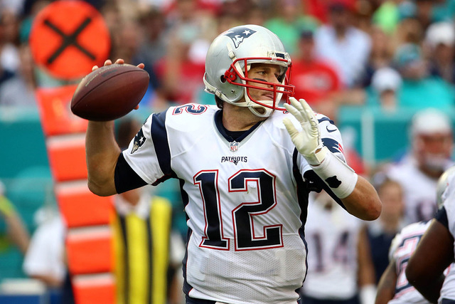 Jan 3, 2016; Miami Gardens, FL, USA; New England Patriots quarterback Tom Brady (12) scrambles during the second half against the Miami Dolphins at Sun Life Stadium. The Dolphins won 20-10. (Steve ...
