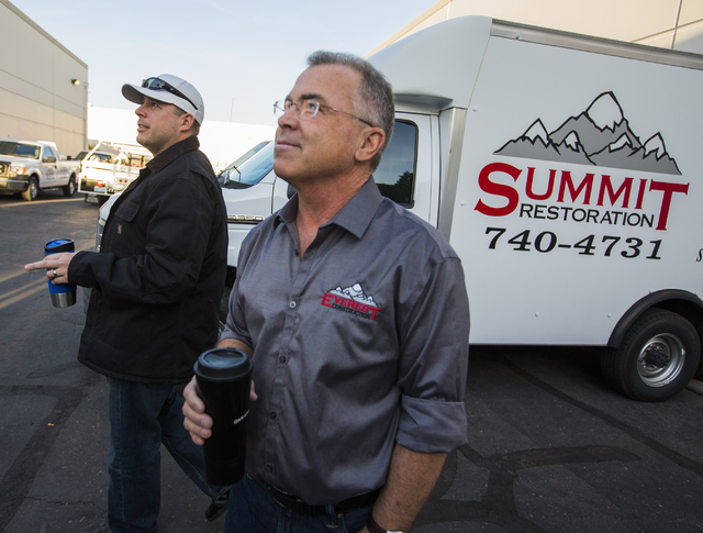 Will Dellaechaie, left, president of Summit Restoration and co-owner/managing member of Everest Construction, and Ken Bagwell, general manager of Everest Construction, monitor a work crew on Frida ...