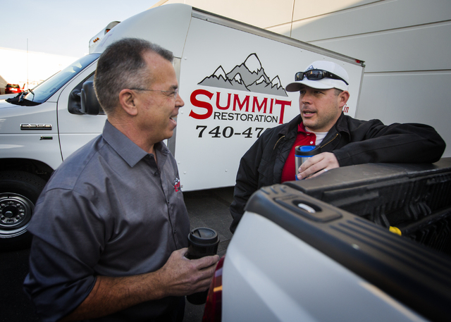 Ken Bagwell, left, general manager of Everest Construction and Will Dellaechaie, president of Summit Restoration and co-owner/managing member of Everest Construction, talk on Friday, March 25, 201 ...