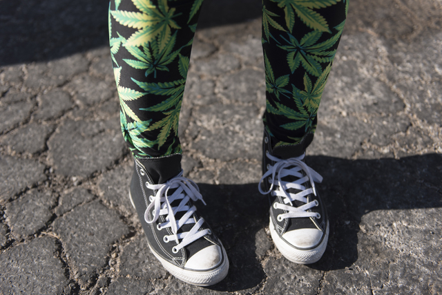 Vicky Sprano of Green Light Productions, poses to show her marijuana-themed pants at Sahara Wellness during a walking tour of various medical marijuana dispensaries in Las Vegas' "Green District" ...