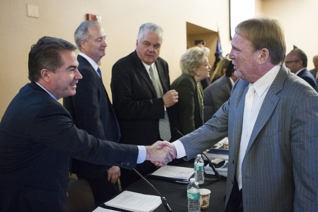 UNLV president Len Jessup, left, shakes hands with Oakland Raiders owner Mark Davis following a meeting to discuss a proposed Las Vegas dome stadium at the Stan Fulton Building at UNLV on Thursday ...