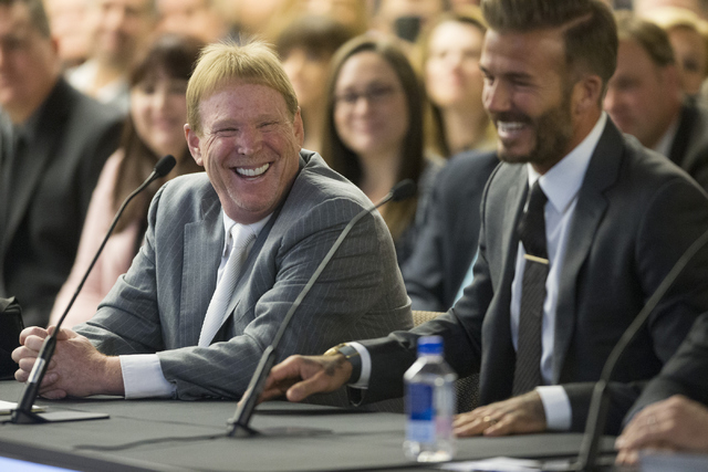 Oakland Raiders owner Mark Davis, left, and former soccer star David Beckham, share a laugh while speaking on a proposed Las Vegas dome stadium during a meeting with local government and UNLV offi ...