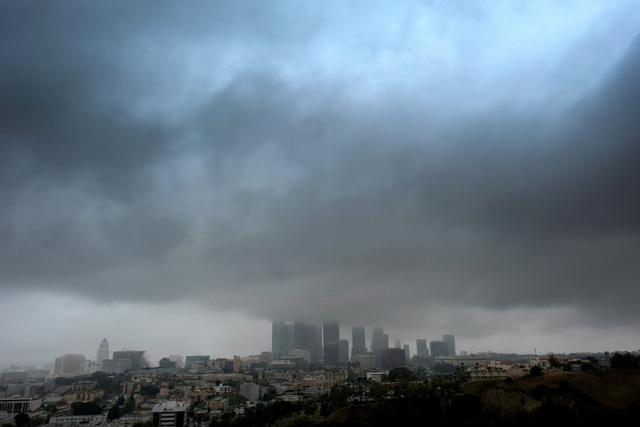 Heavy clouds and rain pass over downtown Los Angeles on Friday, April 8, 2016. (Richard Vogel/The Associated Press)