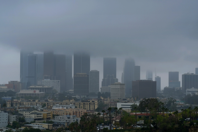 Heavy clouds and rain pass over downtown Los Angeles on Friday, April 8, 2016. (Richard Vogel/The Associated Press)
