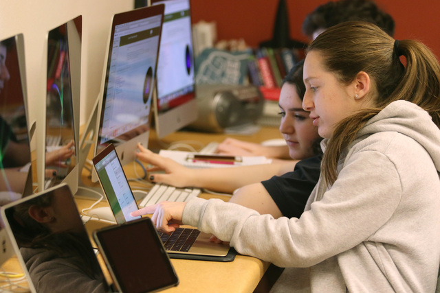 Ari Goodman, 14, right, assists Nicole Derei, 14, center, in Introduction to Computer Programming class at The Adelson Educational Campus Tuesday, March 15, 2016, in Las Vegas. The school expects  ...