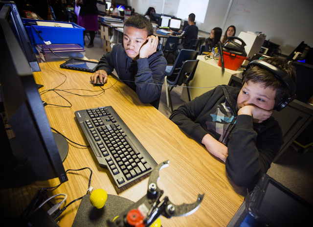 Silvestri Junior High School students Trajon Saap, left, and Trevor Gates views a robotics video during class on Tuesday, March 29, 2016. The school recently received a $14.1 million grant to purc ...