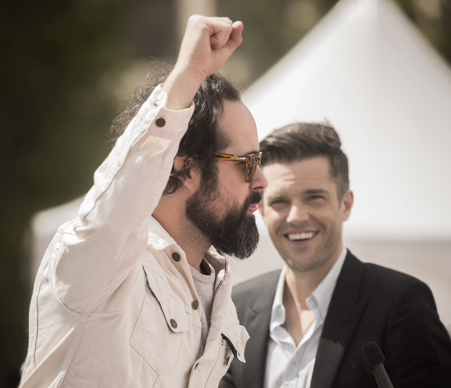 The Killers band members Ronnie Vannucci, left, raises his hand as lead singer Brandon Flowers looks on during a press conference at Toshiba Plaza on Wednesday, April 6, 2016. Jeff Scheid/Las Vega ...