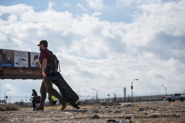 James Fouts carries a garbage bag during the cleanup of the newly acquired UNLV site off of Tropicana Avenue east of Koval Lane in Las Vegas on Saturday, April 9, 2016.  (Joshua Dahl/Las Vegas Rev ...