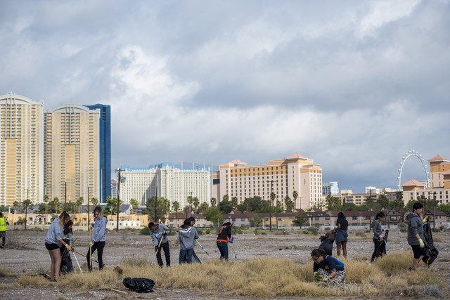 Volunteers pick up garbage during the cleanup of the newly acquired UNLV site off of Tropicana Avenue east of Koval Lane in Las Vegas on Saturday, April 9, 2016.  (Joshua Dahl/Las Vegas Review-Jou ...