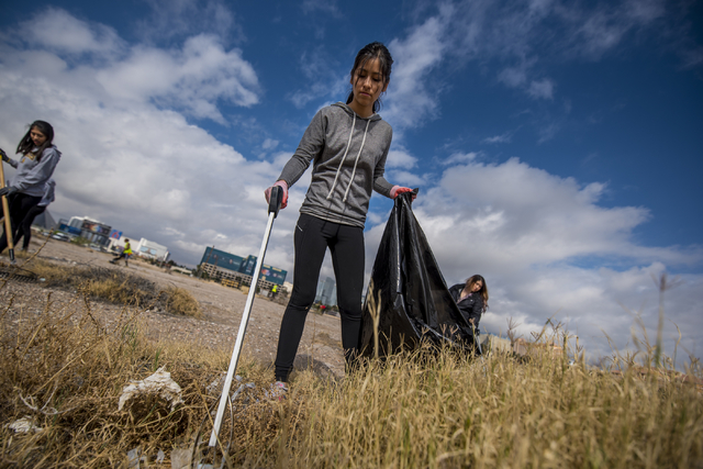 Rachel Ugarte picks up garbage during the cleanup of the newly acquired UNLV site off of Tropicana Avenue east of Koval Lane in Las Vegas on Saturday, April 9, 2016. (Joshua Dahl/Las Vegas Review- ...