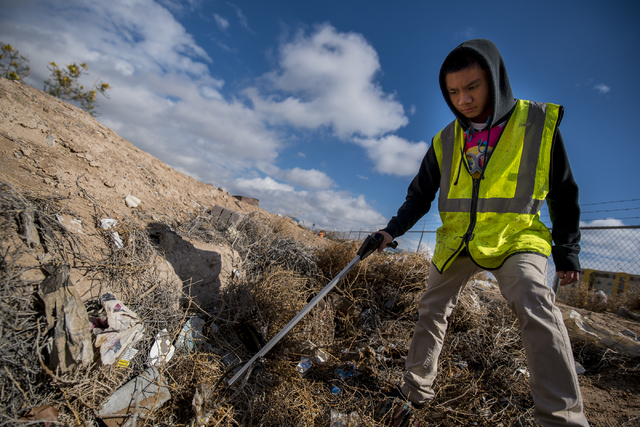 Naphon Meesiri picks up garbage during the cleanup of the newly acquired UNLV site off of Tropicana Avenue east of Koval Lane in Las Vegas on Saturday, April 9, 2016. (Joshua Dahl/Las Vegas Review ...