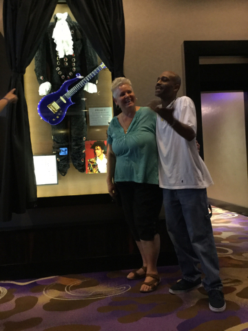 Louise Biancalana of Pahrump and Byron Lemmons of Las Vegas pose for a photo in front of a display of Prince memorabilia at the Hard Rock hotel-casino at 4455 Paradise Road in Las Vegas on Thursda ...