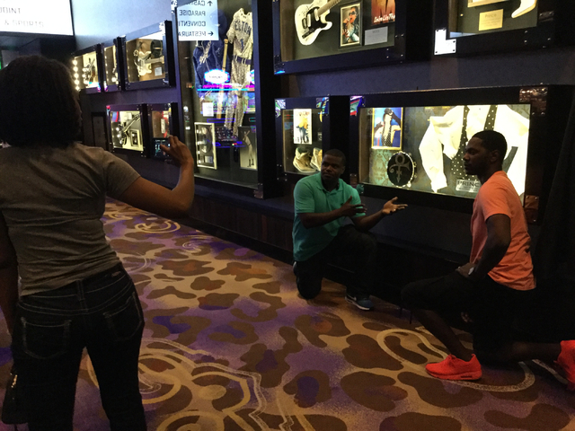 Eric Lucear of Atlanta and Roche Ferrell of Valdosta, Ga., pose for a picture in front of a display of Prince memorabilia at the Hard Rock hotel-casino at 4455 Paradise Road in Las Vegas on Thursd ...