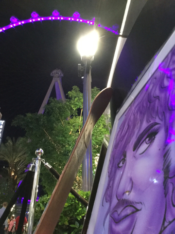 Artwork depicting Prince rests against an artist's workbench at the Linq Promenade in Las Vegas on Thursday, April 21, 2016. The High Roller was lighted purple in memory of Prince, who died Thursd ...