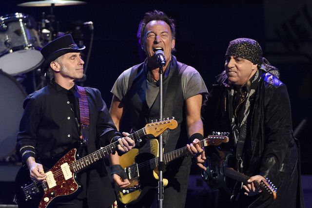 Bruce Springsteen, center, performs with Nils Lofgren, left, and Steven Van Zandt of the E Street Band during their concert at the Los Angeles Sports Arena on Tuesday, March 15, 2016, in Los Angel ...