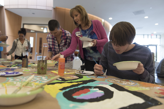 Isaac Antflick, 15, right, Marcy Cherek, center, and Stephanie Helms, second from left, work on a collaborative art project at Yiddish Las Vegas: A Music & Culture Festival at Temple Sinai in  ...