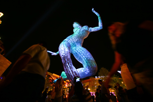 People check out the 40-foot tall Bliss Dance sculpture at The Park, outside of the T-Mobile Arena and New York New York hotel-casino in Las Vegas on Monday, April 6, 2016.  (Chase Stevens/Las Veg ...