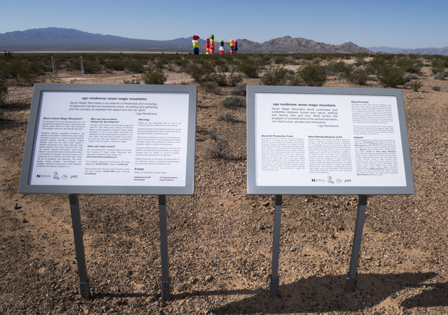 Informational plaques introduce visitors to Seven Magic Mountains -- a large-scale, site-specific public artwork by the artist Ugo Rondinone near the Jean Dry Lake south of Las Vegas on Monday, Ma ...