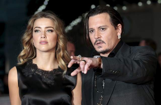 Cast member Johnny Depp and his actress wife Amber Heard arrive for the premiere of the British film &quot;Black Mass&quot; in London, Britain October 11, 2015. REUTERS/Suzanne Plunkett/Files
