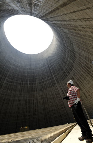 FILE - In this June 2, 2011 file photo, Tennessee Valley Authority worker Damien Powe stands inside one of the two the 500-foot cooling towers at the Bellefonte Nuclear Plant site in Hollywood, Al ...