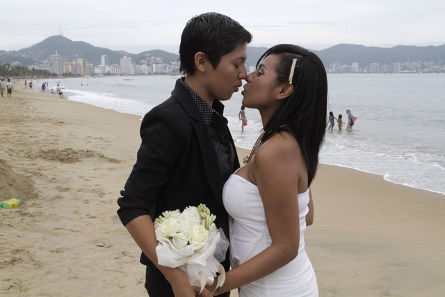 An unidentified same-sex couple kisses during a group wedding for lesbian, gay, bisexual and transgender couples in Acapulco, Mexico, July 10, 2015
