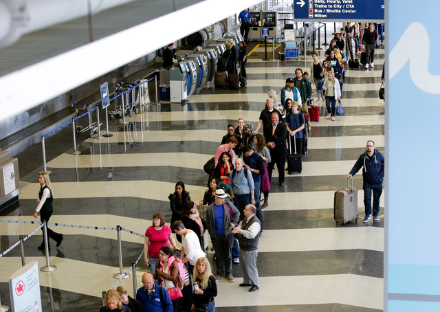 In this May 16, 2016 file photo, a long line of travelers waiting for the TSA security check point at O'Hare International airport in Chicago. (AP Photo/Teresa Crawford, File)