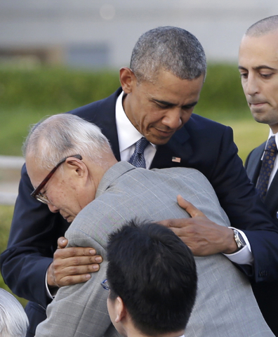 U.S. President Barack Obama hugs Shigeaki Mori, an atomic bomb survivor; creator of the memorial for American WWII POWs killed at Hiroshima, during a ceremony at Hiroshima Peace Memorial Park in H ...