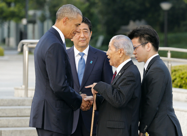 U.S. President Barack Obama, left, shakes hands and chats with Sunao Tsuboi, second right, a survivor of the 1945 atomic bombing and chairman of the Hiroshima Prefectural Confederation of A-bomb S ...