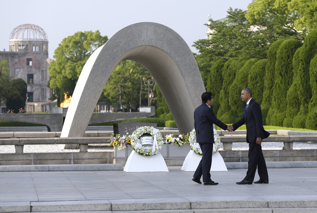 U.S. President Barack Obam, right, and Japanese Prime Minister Shinzo Abe shake hands after laying wreaths at Hiroshima Peace Memorial Park in Hiroshima, western, Japan, Friday, May 27, 2016. Obam ...