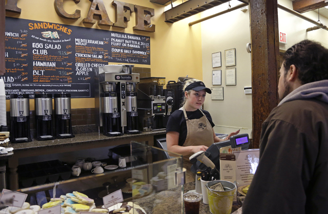 In this Wednesday, March 23, 2016, photo, Kayla Mitchell serves a customer at Good Day Cafe in North Andover, Mass. On Friday, May 27, 2016, the Commerce Department issues the second of three esti ...