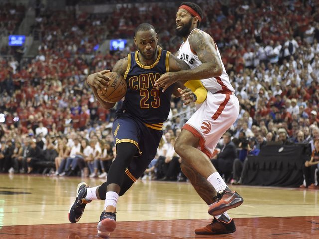 Cleveland Cavaliers forward LeBron James drives to the basket as Toronto Raptors forward James Johnson defends during the second half of Game 6 of the NBA basketball Eastern Conference finals, Fri ...