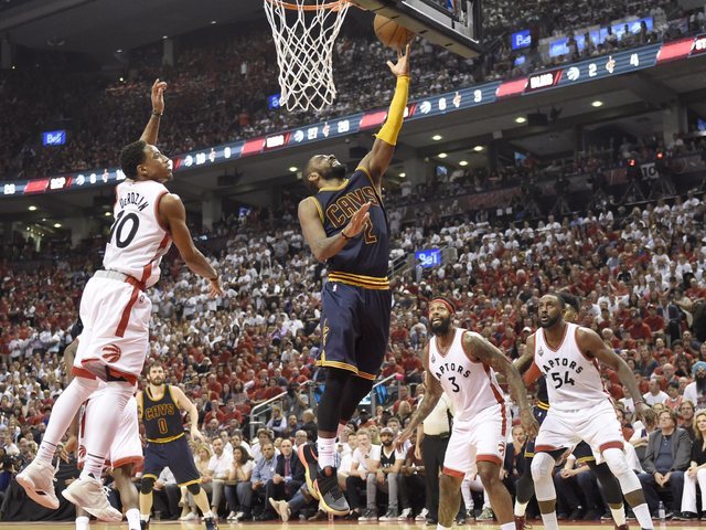 Cleveland Cavaliers guard Kyrie Irving releases a lay-up as Toronto Raptors guard DeMar DeRozan (10) defends during the second half of Game 6 of the NBA basketball Eastern Conference finals, Frida ...