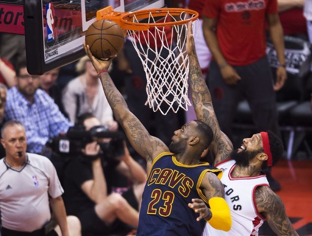 Cleveland Cavaliers forward LeBron James (23) drives past Toronto Raptors forward James Johnson during the second half of Game 6 of the NBA basketball Eastern Conference finals, Friday, May 27, 20 ...