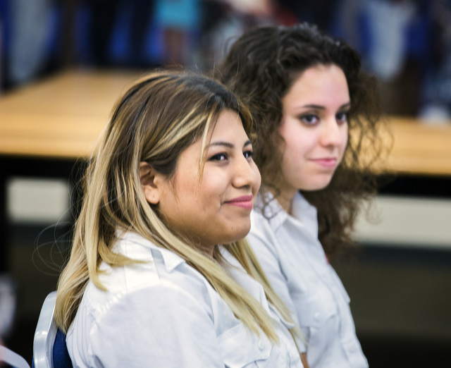 Yessenia Hicks, left, and Lin Martinez, students in the 911 Program at Veterans Tribute Career and Technical Academy, attend a press conference on Tuesday, May 10, 2016. The students helped produc ...