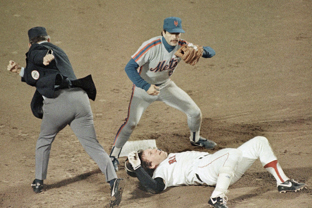 Boston Red Sox Rich Gedman rolls over after being tagged out at second base by New York Mets Wally Backman while trying to stretch a single into a double during sixth inning action in the fourth g ...