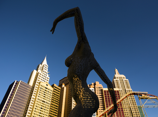 Bliss Dance sculpture created by artist Marco Cochrane is seen with New York-New York in the background on  Wednesday, March 23, 2016. Jeff Scheid/Las Vegas Review-Journal Follow @jlscheid