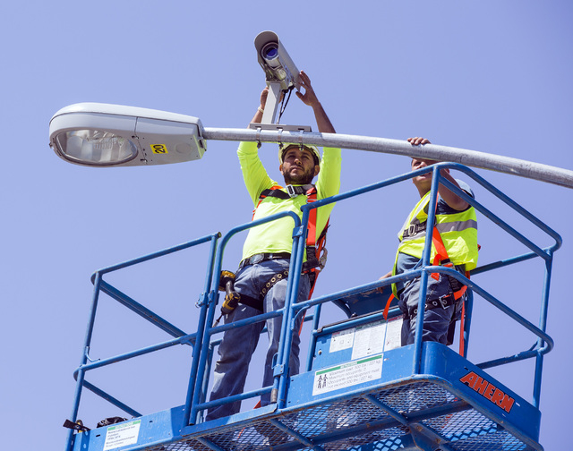 Edgar Vasquez, adjusts a traffic camera on the first traffic light in Baker, Cal. on Monday, May, 23, 2016. The owner of Baker Travel Plaza spent four years trying to install the signal because it ...