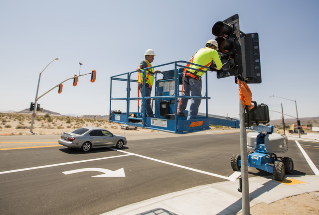 A work crew installs the first traffic light in Baker, Cal. on Monday, May, 23, 2016. The owner of Baker Travel Plaza spent four years trying to install the signal because it is cheaper than a tra ...