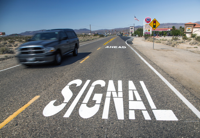 A sign painted on Baker Boulevard inform drivers of the first traffic light in Baker, Cal. on Monday, May, 23, 2016. The owner of Baker Travel Plaza spent four years trying to install the signal b ...