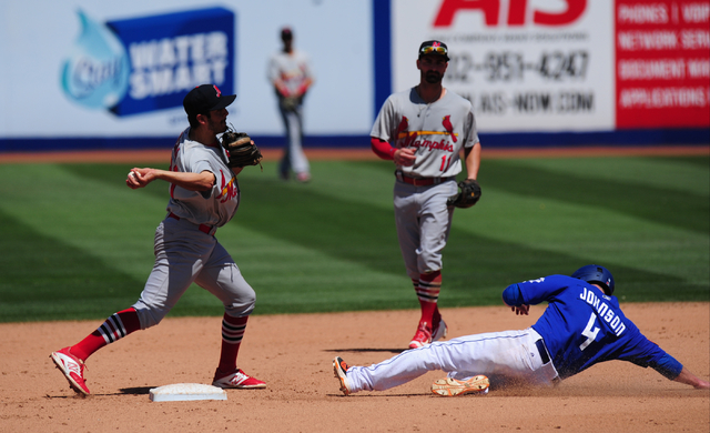 Memphis Redbirds shortstop Alex Mejia turns a double play as Las Vegas 51s base runner Kyle Johnson slides into second base in the fourth inning of their Triple-A minor league baseball game at Cas ...