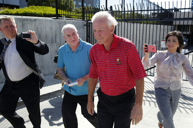 Bill Walters, third from left, is surrounded by reporters as he walks out of the Lloyd George U.S. Courthouse Thursday, May 19, 2016, in Las Vegas. Federal authorities in New York announced an ins ...