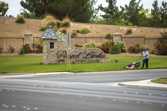 A man cuts the grass out front of Royal Links Golf Club in Las Vegas on Friday, May 20, 2016. Joshua Dahl/Las Vegas Review-Journal