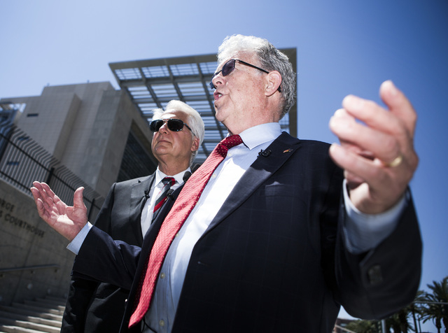 Attorneys Larry Klaymam, left, Joel Hansen, representing Nevada rancher Cliven Bundy, talks to the media in front of Lloyd George U.S. Courthouse after filing a lawsuit  against President Barack O ...